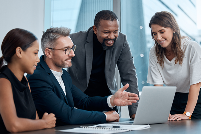 Corporate, meeting and business people with laptop in boardroom for planning, teamwork or review. Diversity, collaboration and staff with proposal, idea or working on report for recruitment agency.