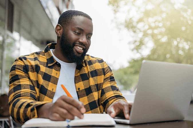 barbri_young-man-taking-notes-laptop_page-image