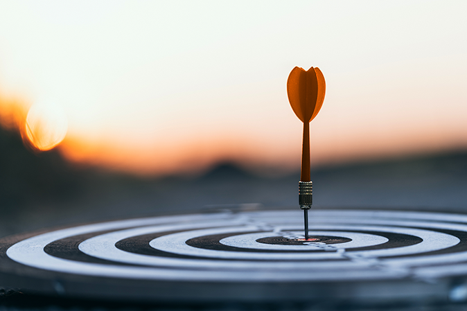 Arrow sticking out of the bullseye of a target